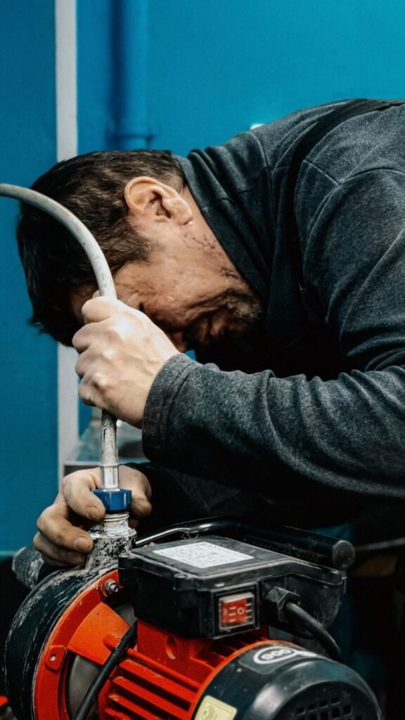 Technician servicing a sump pump